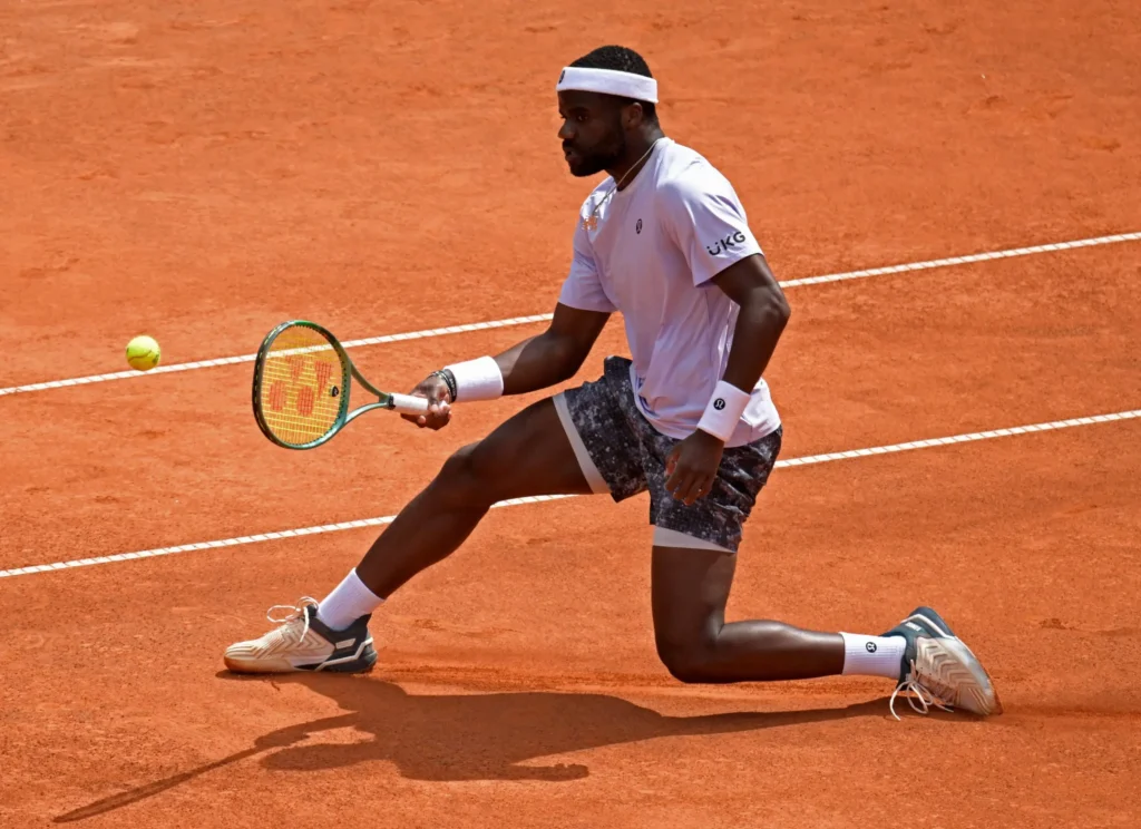 Novak Djokovic celebrates his victory at the 2025 French Open, showcasing dominance amid surprising upsets.