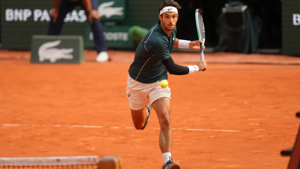 Lorenzo Musetti celebrates his victory over Frances Tiafoe in a thrilling quarterfinal match at Roland Garros 2025.
